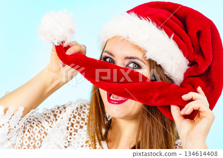 Happy woman in christmas santa hat 134614408