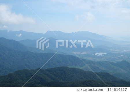 Vietnam Danang Misty mountains and lush forest view from Ba Na Hills near Da Nang Vietnam panoramic scenic landscape with clouds fog and tropical greenery. 134614827