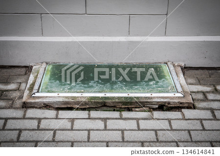 Old Basement Window Covered with Dirty Glass and Concrete Frame Old Basement Window Covered with Dirty Glass and Concrete Frame 134614841