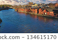 Porvoo, Finland - December 08, 2020: Scenic view of a river lined with charming red wooden houses, reflecting on the water surface under a beautiful sky 134615170