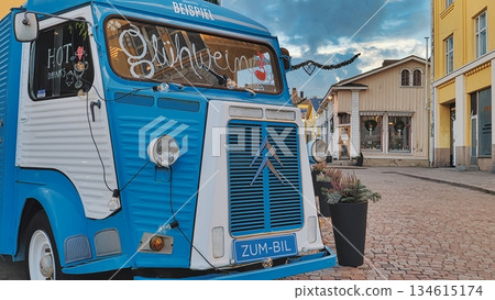 Porvoo, Finland - December 08, 2020: Blue Citroen food truck is parked on a cobblestone street, surrounded by quaint buildings, creating a vibrant and inviting atmosphere Porvoo, Finland - December 08, 2020: Blue Citroen food truck is parked on a cobblestone street, surrounded by quaint buildings, creating a vibrant and inviting atmosphere 134615174