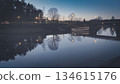 Porvoo, Finland - December 08, 2020: Scenic view of a river at dusk, showcasing reflections of trees and lights along the water, creating a tranquil evening atmosphere 134615176