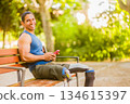 Venezuelan amputee man smiling and resting in park 134615397