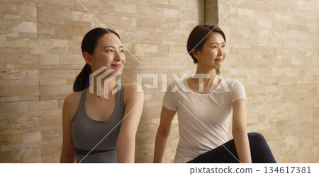 Two middle-aged women doing hot yoga 134617381