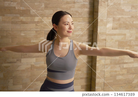 Woman in her 20s, hot yoga Woman in her 20s, hot yoga 134617389