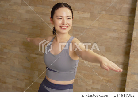 Woman in her 20s, hot yoga Woman in her 20s, hot yoga 134617392