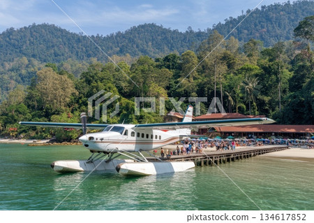 Traveler Arriving at Tropical Island Paradise by Seaplane with Scenic Background Traveler Arriving at Tropical Island Paradise by Seaplane with Scenic Background 134617852