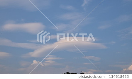 Mysterious lenticular clouds floating beautifully in the blue sky - A natural landscape of refreshing and calm sky 134618423