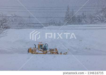 Snowplows and roads working in heavy snowfall early in the morning 134618735