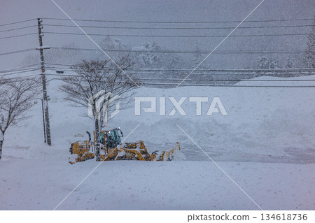 Snowplows and roads working in heavy snowfall early in the morning 134618736