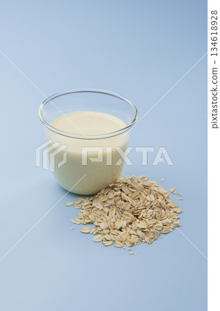 Simple material of oat milk placed on a pale blue background 134618928