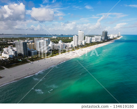 Miami south beach aerial view. Sea beach seashore and coastline. Summer vacation in Miami, Florida. Sea vacation on beach. Aerial marina view. Turquoise waters. Beach vacation. Coastline of Miami 134619180