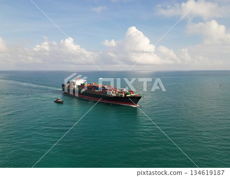 Aerial view cargo ship entering harbor. Cargo business. Container ship. Shipping logistics. Commercial shipping. Cargo ship in sea, aerial view. Freight container vessel. Heavy cargo shipment 134619187