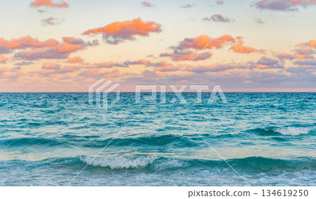 Sunrise with sea beach. Dramatic sunrise horizon at sea. Romantic summer vacation on sunset seascape. Sea sunset on ocean. Sunset seascape at summer vacation Sunrise with sea beach. Dramatic sunrise horizon at sea. Romantic summer vacation on sunset seascape. Sea sunset on ocean. Sunset seascape at summer vacation 134619250