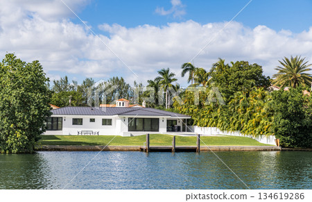 Vacation building in summer. Luxury waterfront house. Hotel building. Residential architecture. Modern building. Residential apartment in waterfront city. Waterfront landscape with house 134619286