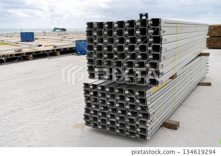 Aluminum extrusion profile. Construction site storage with aluminum tubes. Steel extrusion. Industry material. Aluminum industry extrusion at building construction site. Aluminum building structure Aluminum extrusion profile. Construction site storage with aluminum tubes. Steel extrusion. Industry material. Aluminum industry extrusion at building construction site. Aluminum building structure 134619294