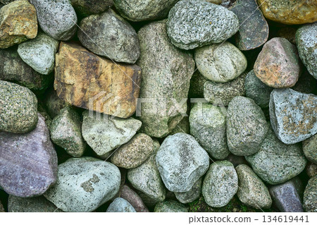 Various Sizes and Shapes of Stones Stacked Together in a Natural Setting Outdoors During Daylight Hours 134619441