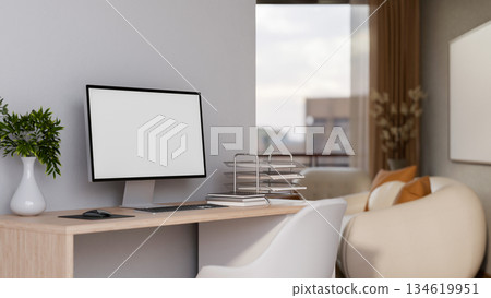 White screen computer and paper tray on wooden table with chair beside white wall of a living room. 134619951