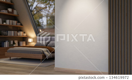 White wall of attic bedroom with grey bed under roof window illuminate by lamp light near bookshelf. White wall of attic bedroom with grey bed under roof window illuminate by lamp light near bookshelf. 134619972
