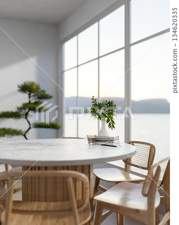 A glass cup of coffee and glasses with books atop marble table with wooden chairs in a white living room. A glass cup of coffee and glasses with books atop marble table with wooden chairs in a white living room. 134620335