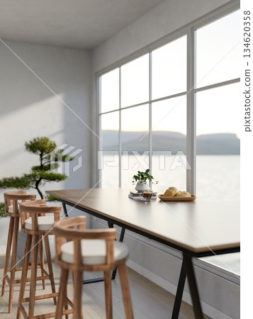 Bread on plate with coffee and pot plants atop books on wooden table with stool chairs in white cafe 134620358