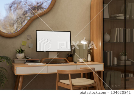 White screen computer on wooden table and chair under an odd shape window in living room or bedroom. 134620841
