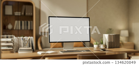 White screen computer with stationary and potted plants on wooden table in living room or study room White screen computer with stationary and potted plants on wooden table in living room or study room 134620849