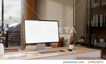 Blank screen computer on wooden table with coffee next to glass cabinet in living room with balcony. 134620855