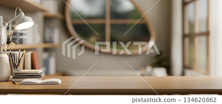 Books and stationary with flower vase and lamp on wooden table in living room with oval shape window Books and stationary with flower vase and lamp on wooden table in living room with oval shape window 134620862