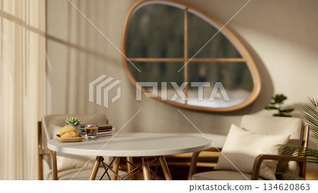 Bread and coffee with books on round wooden table and armchair in living room with oval shape window Bread and coffee with books on round wooden table and armchair in living room with oval shape window 134620863