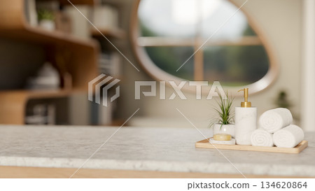 Spa towel and soap with lotion in pump bottle aside potted plant on wooden plate atop marble counter Spa towel and soap with lotion in pump bottle aside potted plant on wooden plate atop marble counter 134620864