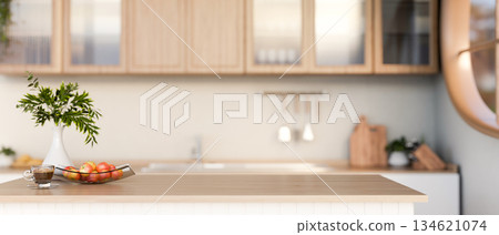 Cup of coffee and apples on plate with flower vase on wooden top counter or dining table in kitchen. Cup of coffee and apples on plate with flower vase on wooden top counter or dining table in kitchen. 134621074