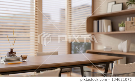 Glass of coffee and book aside flower vase on wooden table in living room or cafe with stylish shelf Glass of coffee and book aside flower vase on wooden table in living room or cafe with stylish shelf 134621075