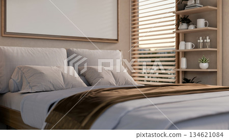 White tone bedroom and blank frame hanging over headboard near wooden window blind and display shelf 134621084