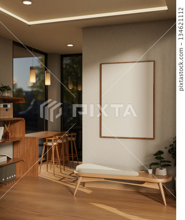 Wooden chair with cushion and bonsai pot under white frame hanging on wall in a cafe or living room. 134621112