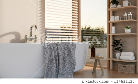White bathtub and towel with body wash and brush on stool chair near wooden shelf in modern bathroom White bathtub and towel with body wash and brush on stool chair near wooden shelf in modern bathroom 134621125