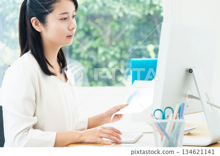 A young woman creating documents on a computer A young woman creating documents on a computer 134621141