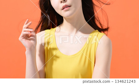 Orange background Middle-aged woman portrait 134621243
