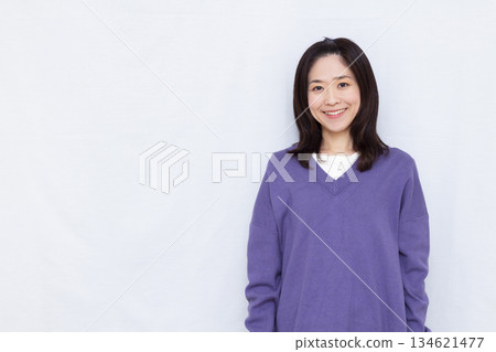 A woman wearing a purple knit 134621477