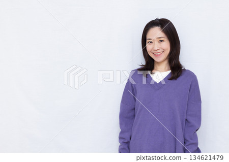 A woman wearing a purple knit 134621479