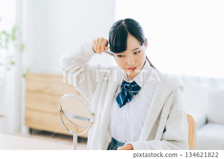 High school girl arranging her bangs 134621822