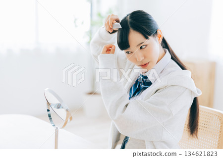 High school girl arranging her bangs 134621823