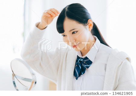 High school girl arranging her bangs 134621905
