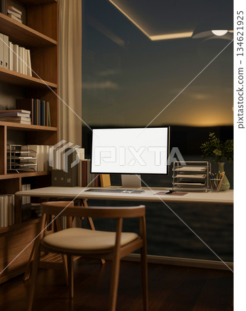 Blank screen computer on table aside bookshelf in a glass wall bedroom or living room in the evening Blank screen computer on table aside bookshelf in a glass wall bedroom or living room in the evening 134621925