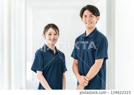 Male and female care staff including care managers, physical therapists, and occupational therapists working in nursing homes, hospitals, and day care centers 134622523