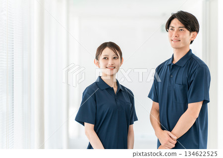 Male and female care staff including care managers, physical therapists, and occupational therapists working in nursing homes, hospitals, and day care centers 134622525