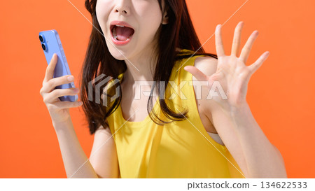 Surprised woman with a smartphone 134622533