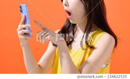 Surprised woman with a smartphone Surprised woman with a smartphone 134622535