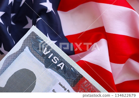 U.S. VISA United States of America. American Tourist or Green Card Visa on flag background close up 134622679