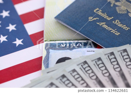 Passport and US Visa for immigration with many money bills close up on USA flag. Concept of immigration visa and taxes for travel Passport and US Visa for immigration with many money bills close up on USA flag. Concept of immigration visa and taxes for travel 134622681
